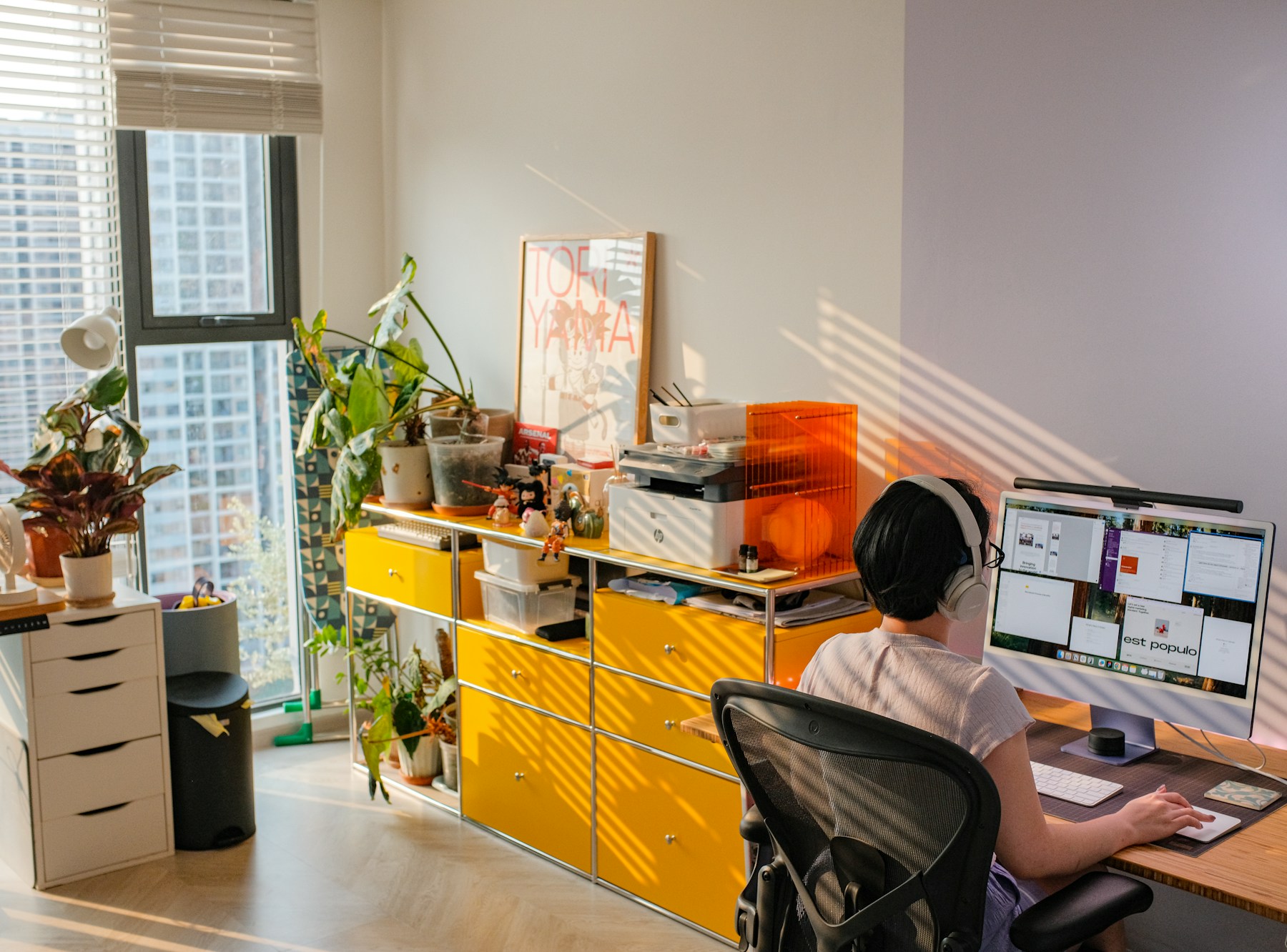 A person is working at a bright home office.